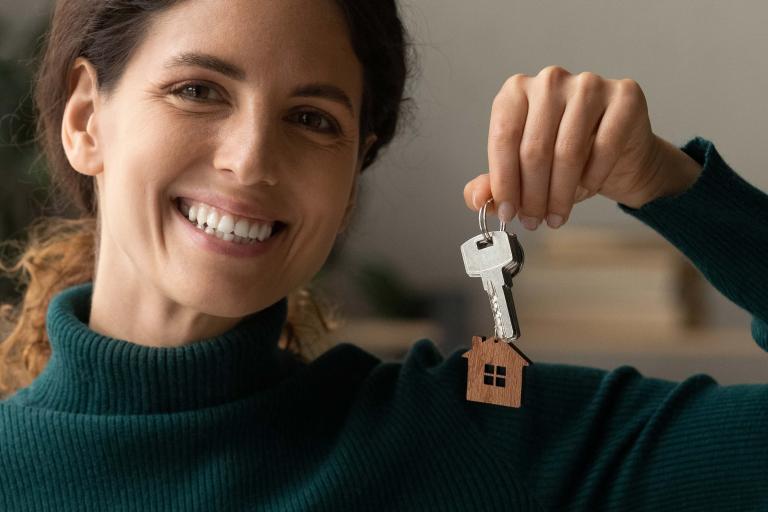 Woman holding key with HWS Logo